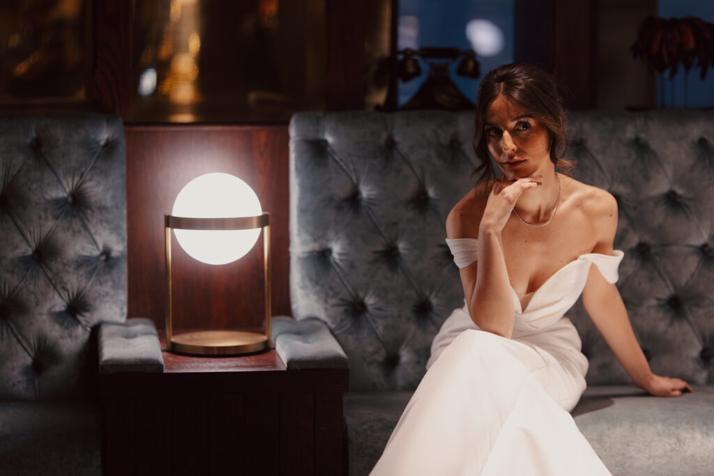 bride poses in Artdeco style bar