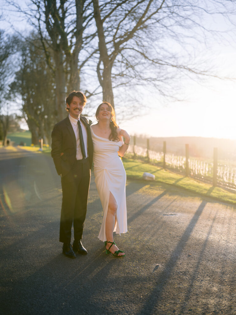 bride and groom pose of photo at sunset bride wares vintage dress