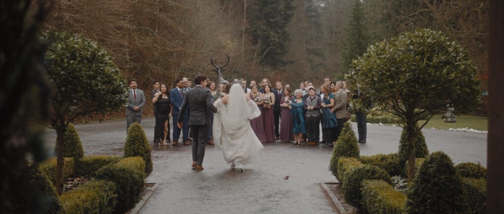 bride and groom walk out to meet wedding guests